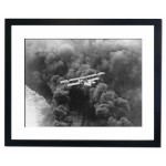 A striking aerial picture of a US Naval seaplane balanced over a dense smoke screen, California 1927 Framed Print