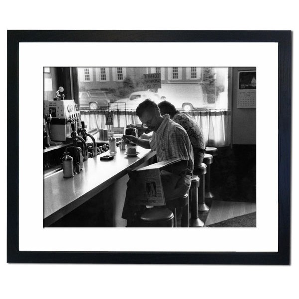 Man having a coffee and reading the morning newspaper in a coffee shop, New Jersey Framed Print
