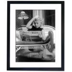 Marilyn Reading the Daily News, 1955 Framed Print