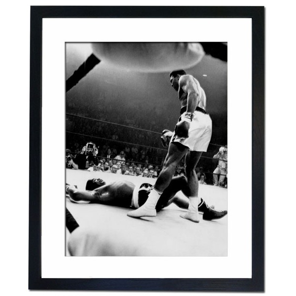 Muhammed Ali towering over Sonny Liston in first round, Lewiston 1965 Framed Print