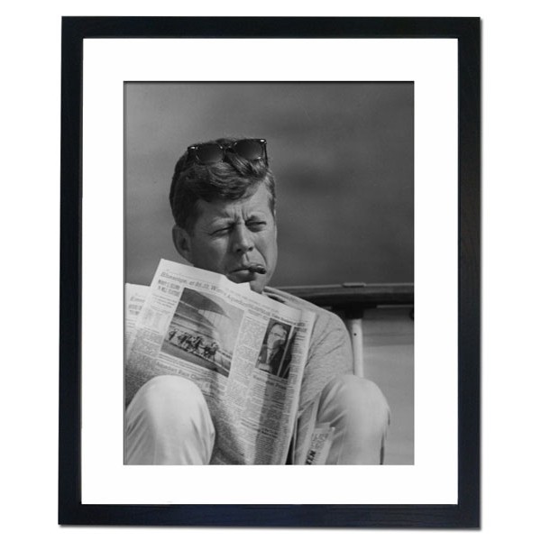 President John F. Kennedy with cigar and New York Times, 1963 Framed Print
